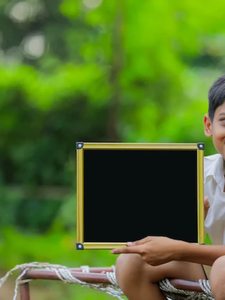 cute-indian-little-child-showing-chalkboard-with-copy-space_75648-3019