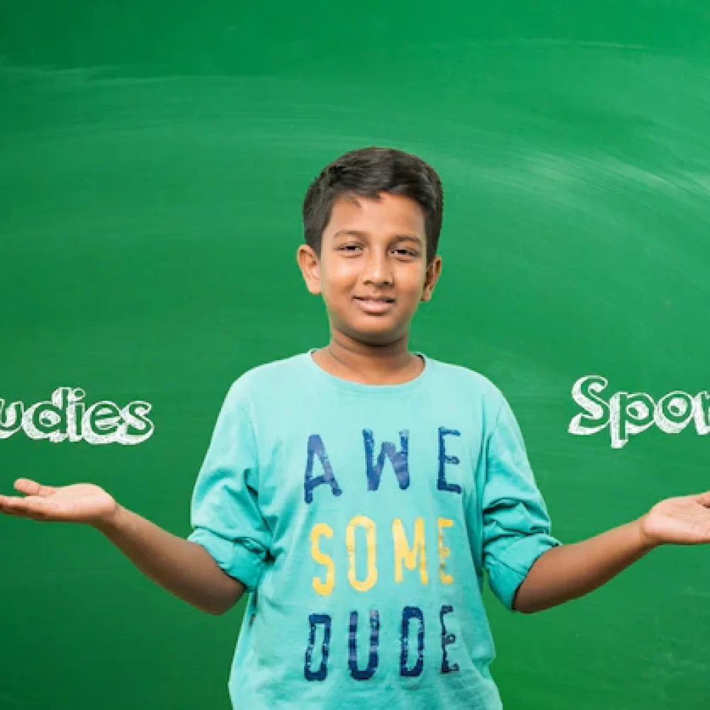 expressive-indian-asian-school-kid-boy-standing-front-green-chalkboard-with-doodles_466689-17307