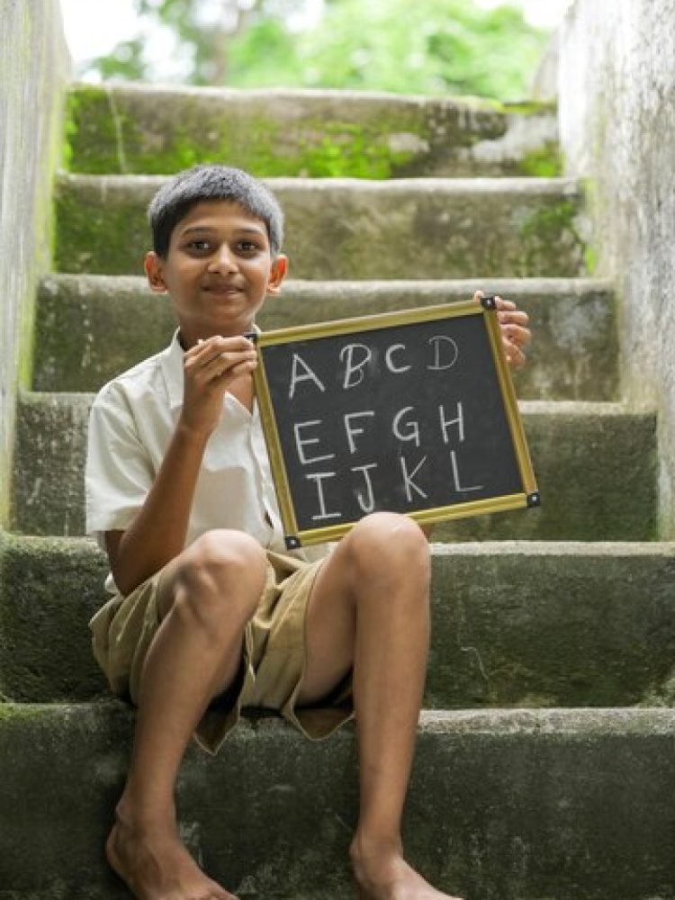 indian-child-writing-b-c-d-alphabet-chalkboard_75648-2666